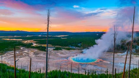 As hot steam rises, a rainbow of colors circles Grand Prismatic Spring