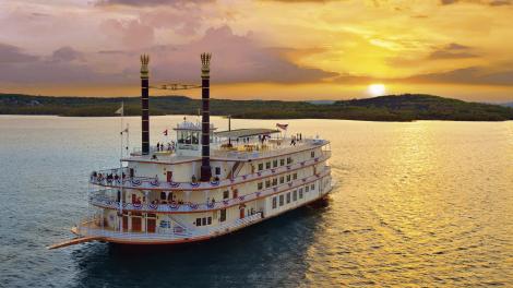 Showboat Branson Belle glides across Table Rock Lake at sunset in Branson, Missouri