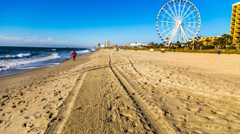 Walking on the sand by the SkyWheel in Myrtle Beach, South Carolina