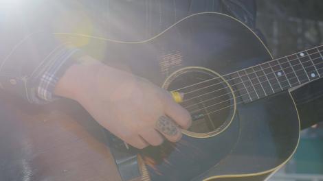 Playing the guitar on a Houston, Texas street