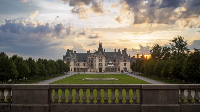 The sun setting behind the Biltmore mansion in Asheville, North Carolina