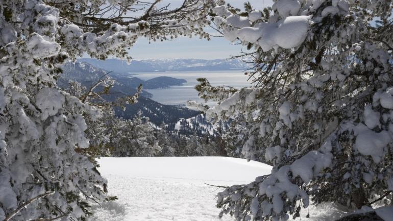 From a mountaintop in winter, a view of Lake Tahoe