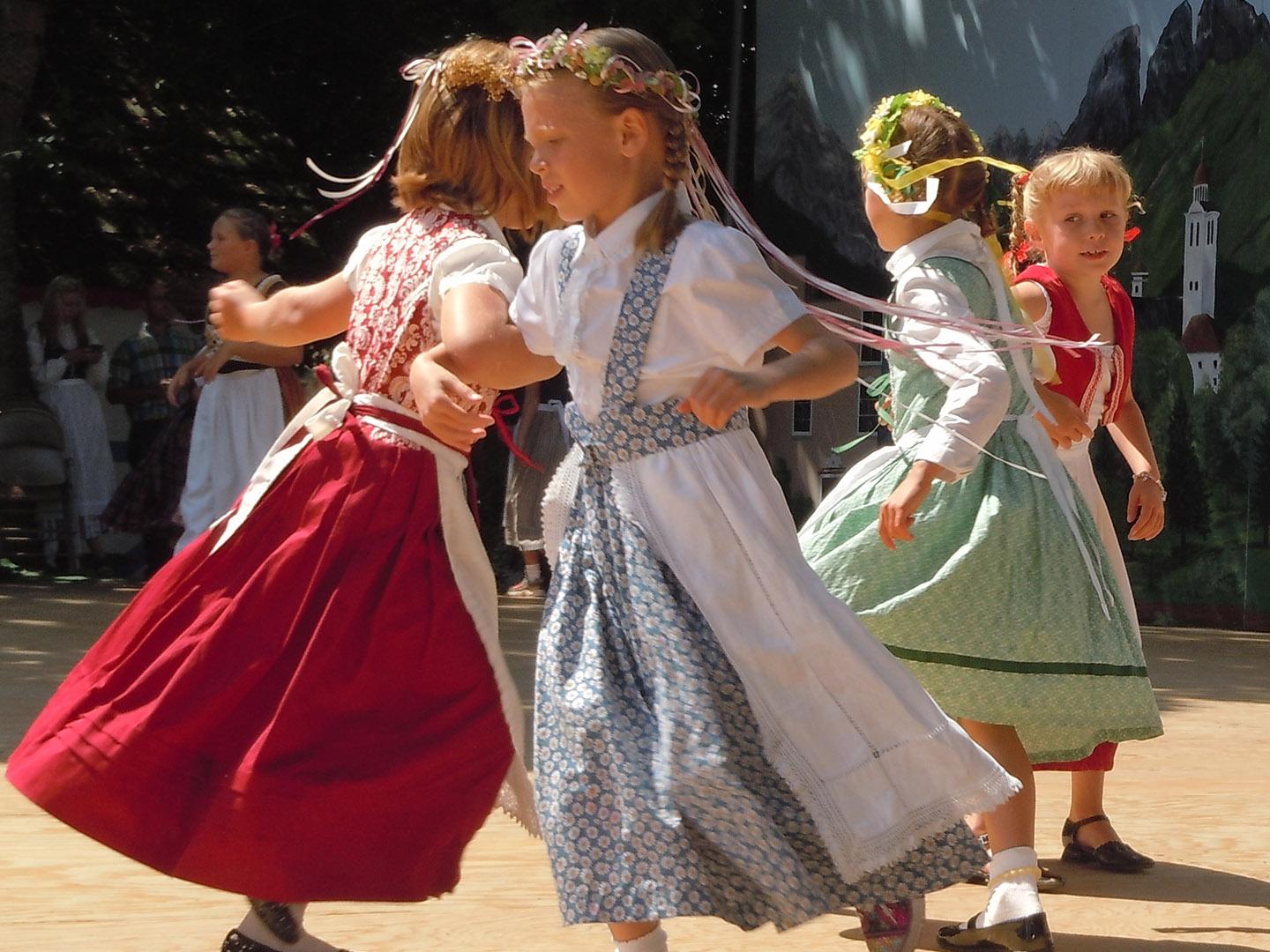 Children dancing in traditional costumes during the Scandinavian Festival in Junction City