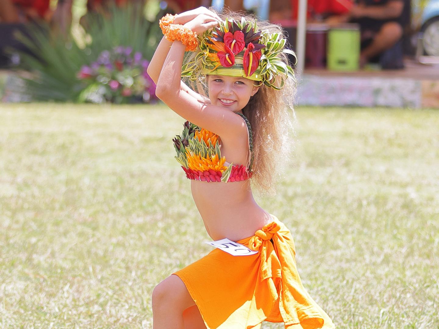 A young dancer celebrating Tahitian culture at the Heiva I Kauai event in Kaua'i