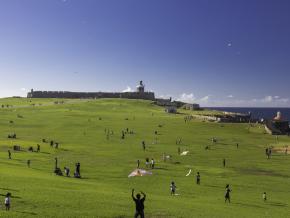 Flying kites on a sunny day at the El Morro Fort 