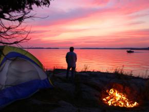 Taking in the tranquil sunset from a secluded waterfront campsite