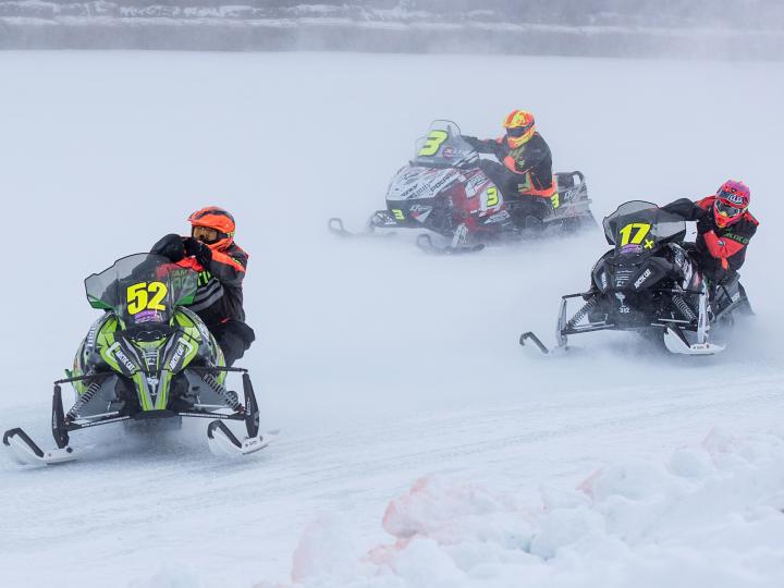 Competitors race through the snow during the I-500 Snowmobile Race in Sault Ste. Marie, Michigan