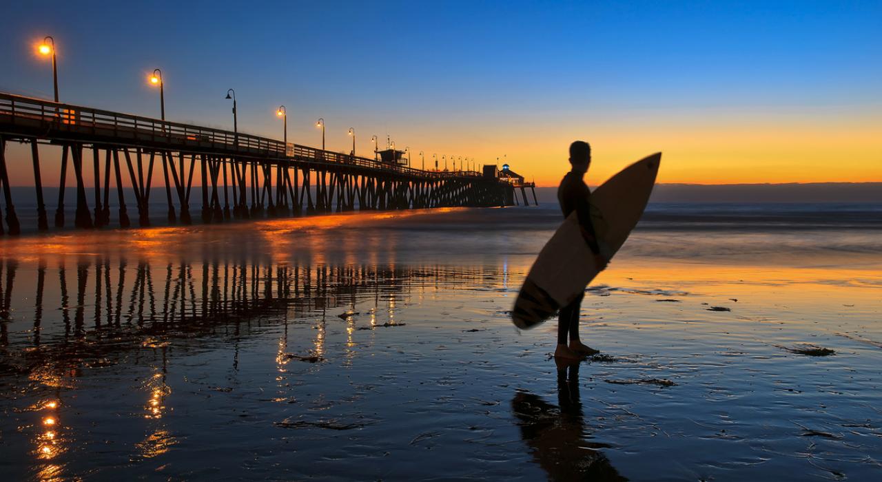 Sunset surfing in the Pacific Ocean near the Imperial Beach Pier south of San Diego