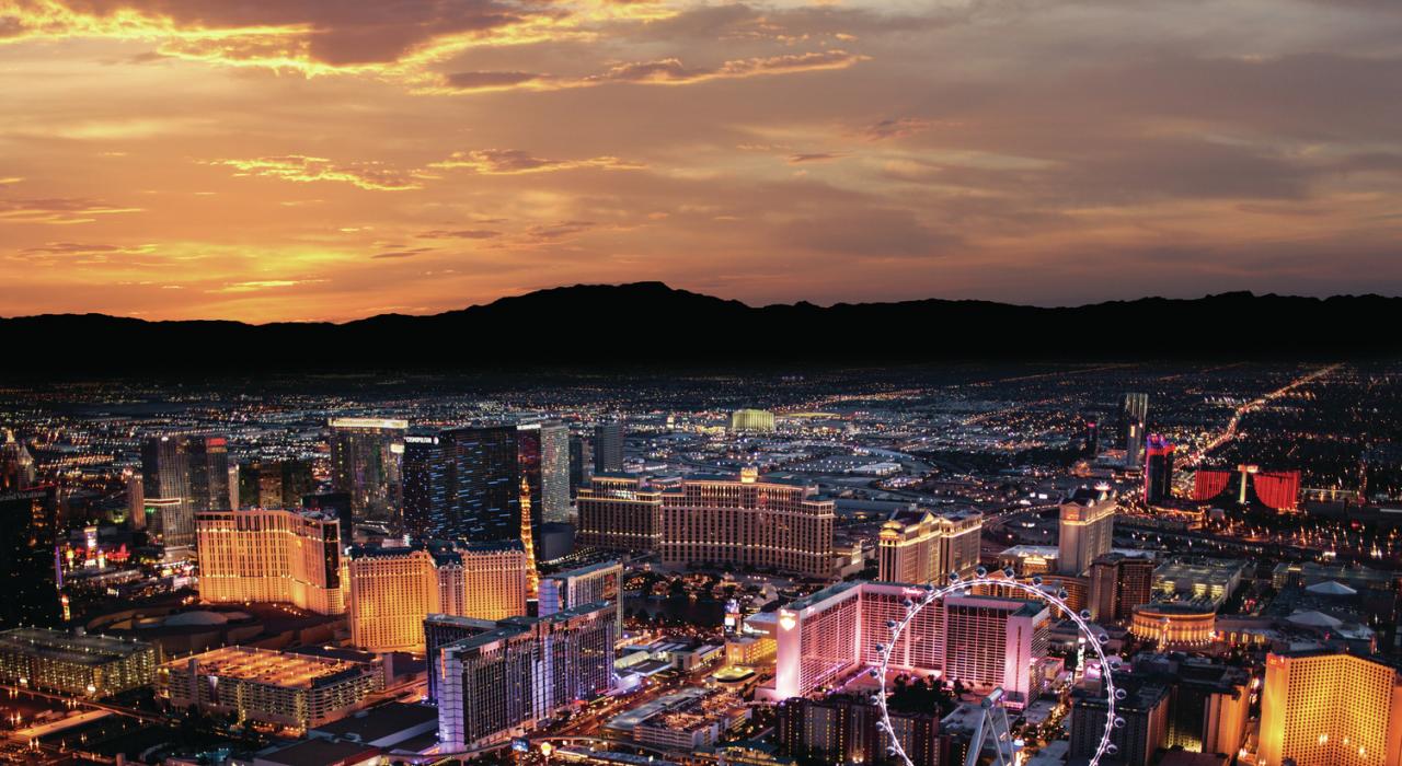 Sunrise over the Las Vegas Strip, framed by a mountainous landscape