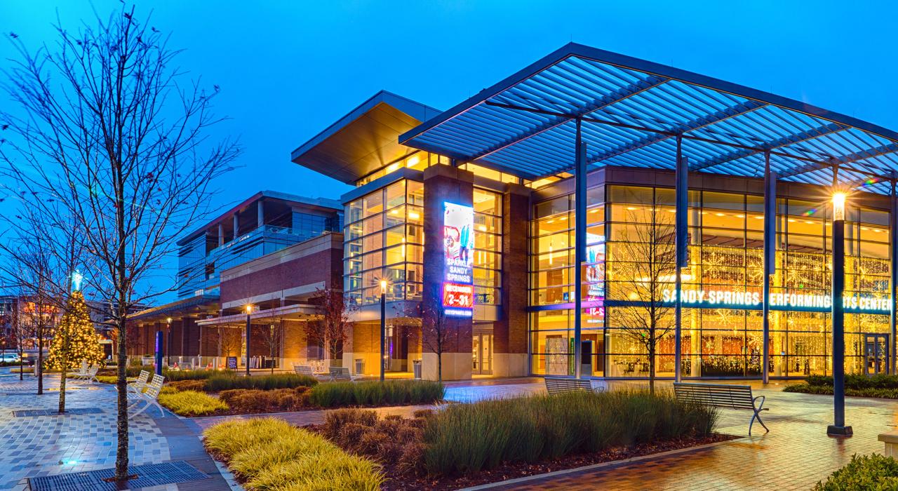 The Sandy Springs Performing Arts Center illuminated at dusk