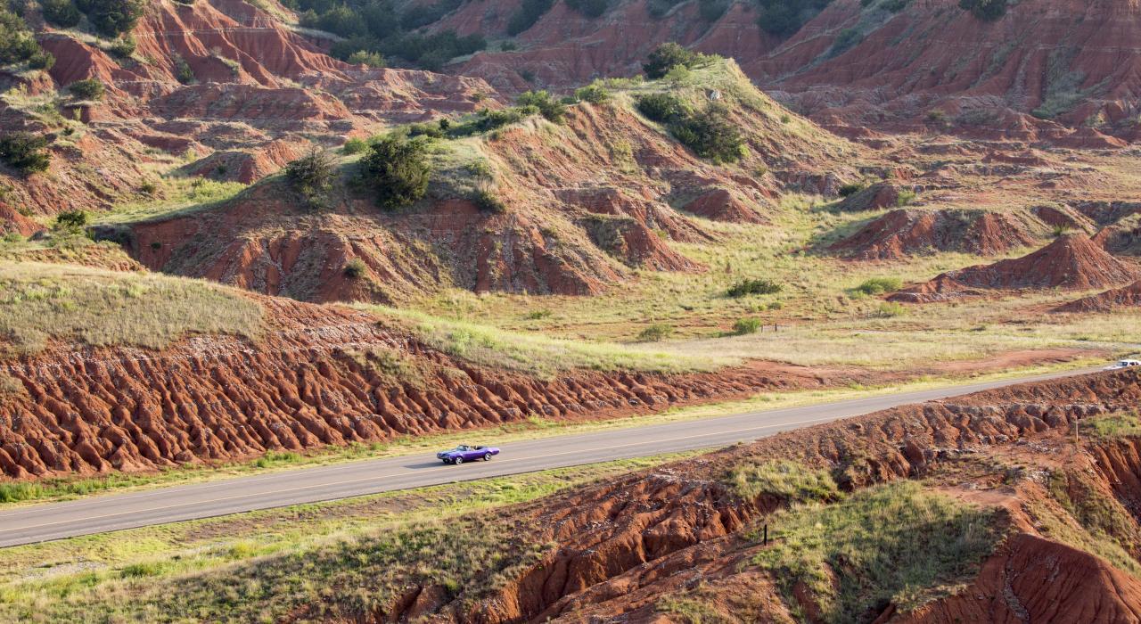 A classic car cruising through Gloss Mountain State Park in Fairview, Oklahoma
